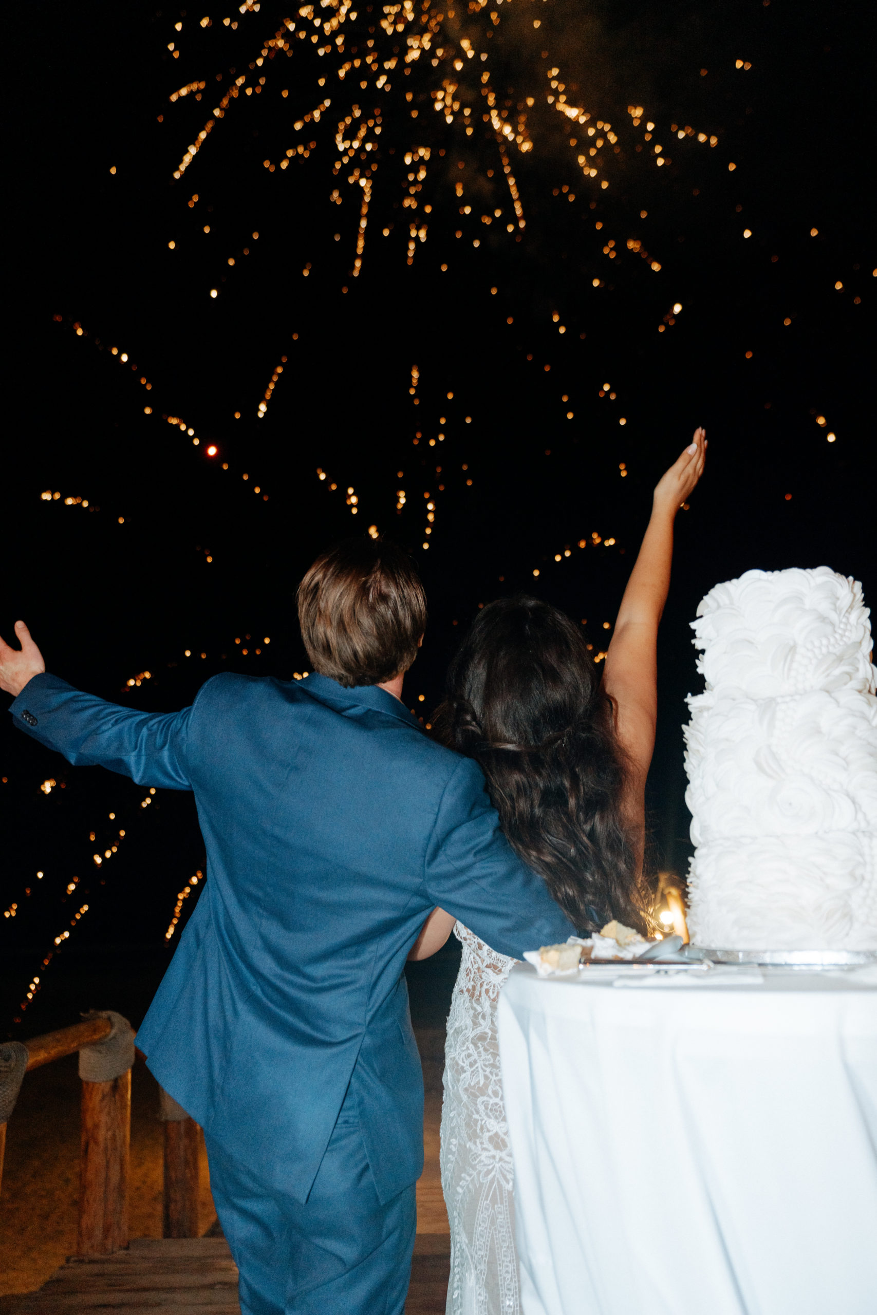 bride and groom looking at fireworks
