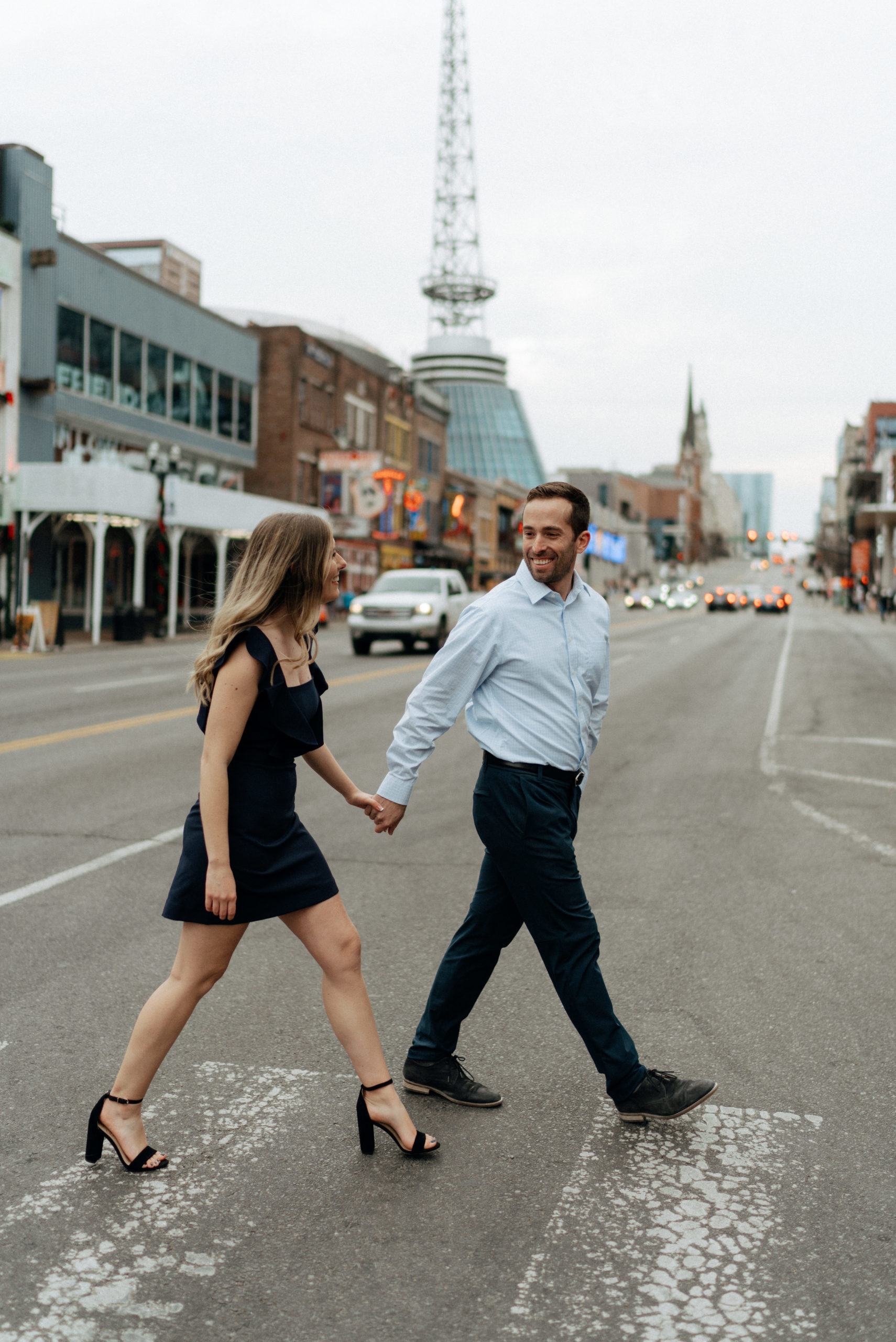 couple walking together in downtown nashville for their engagement session