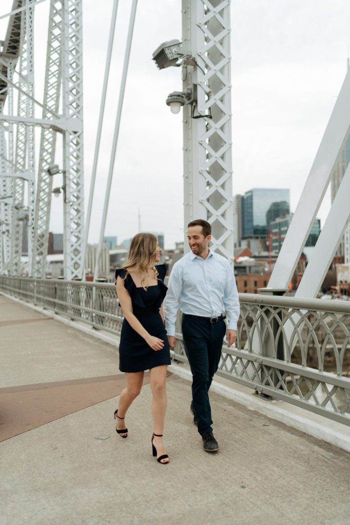 A couple posing for an engagement session in downtown Nashville