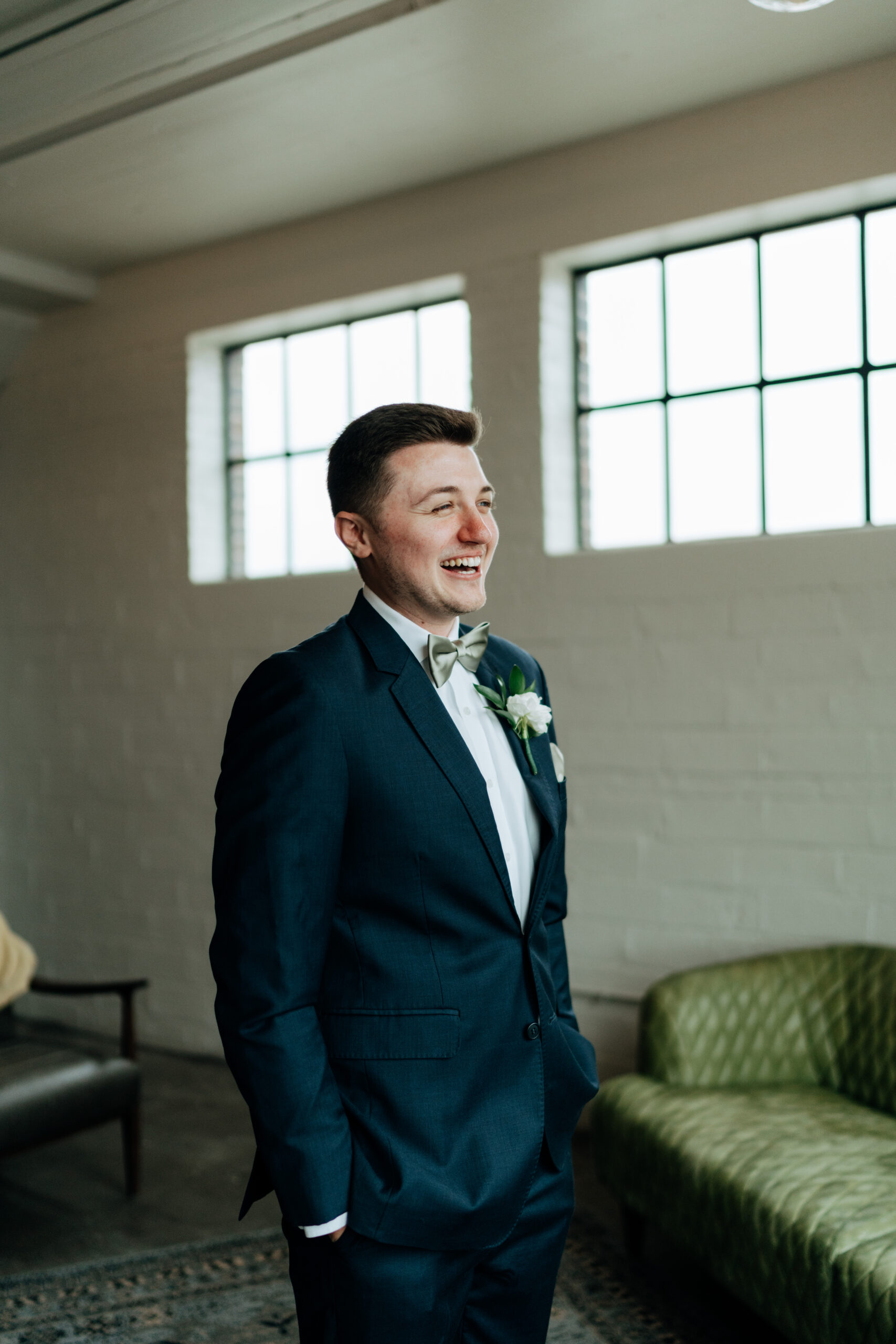 This is a picture of a groom smiling on his wedding day