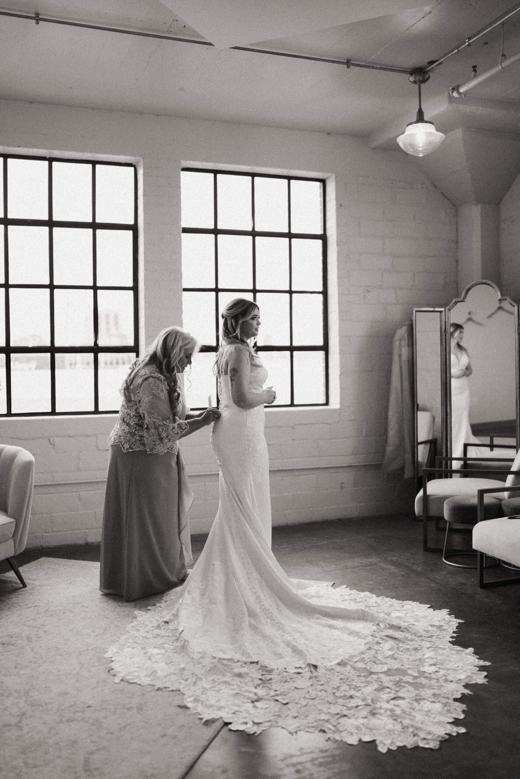 This is a picture of a mom helping her daughter get married on her wedding day