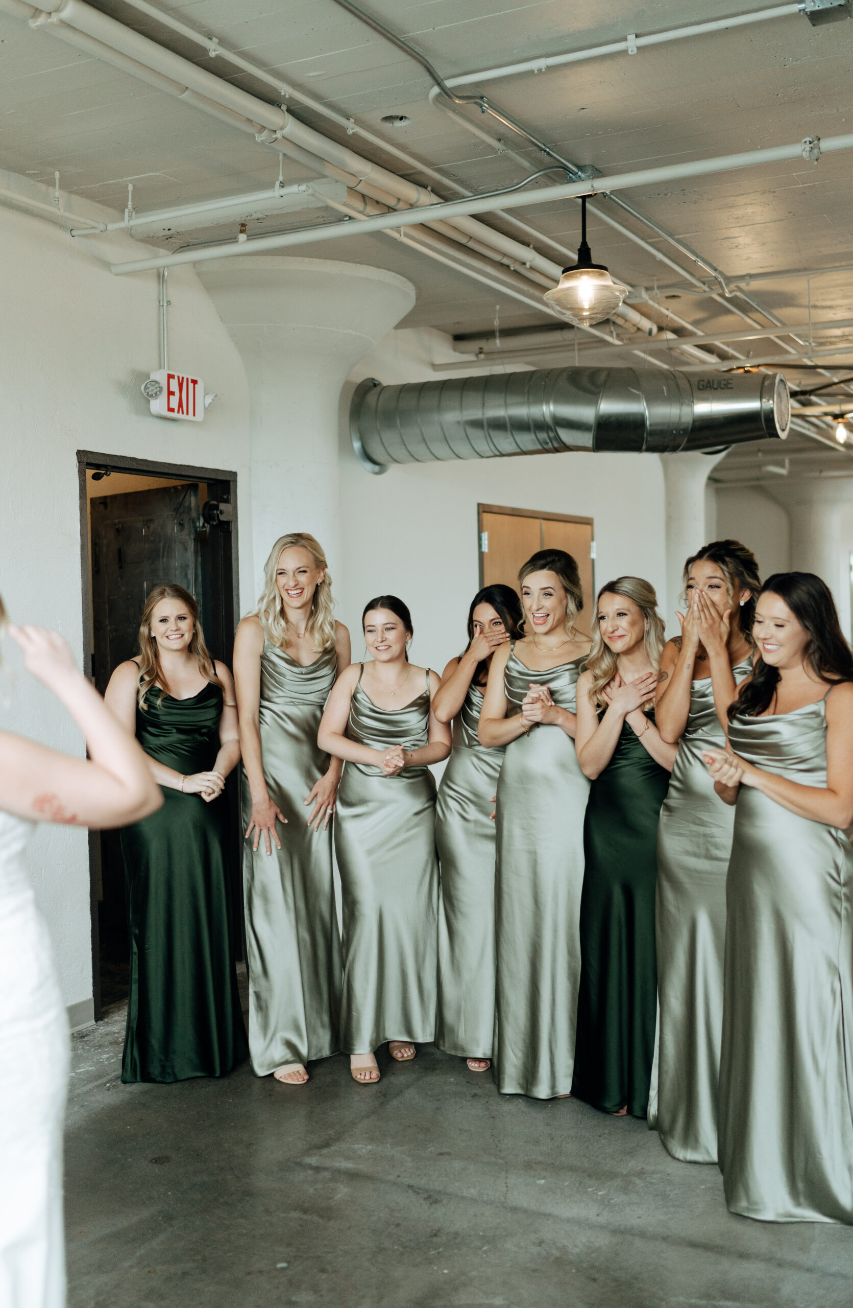 This is a picture of bridesmaids seeing the bride for the first time on her wedding day