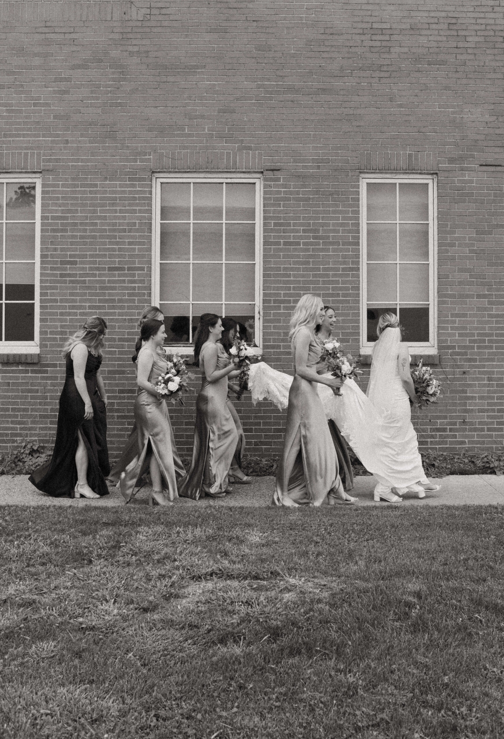 This is a picture of bridesmaids taking picture with a bride