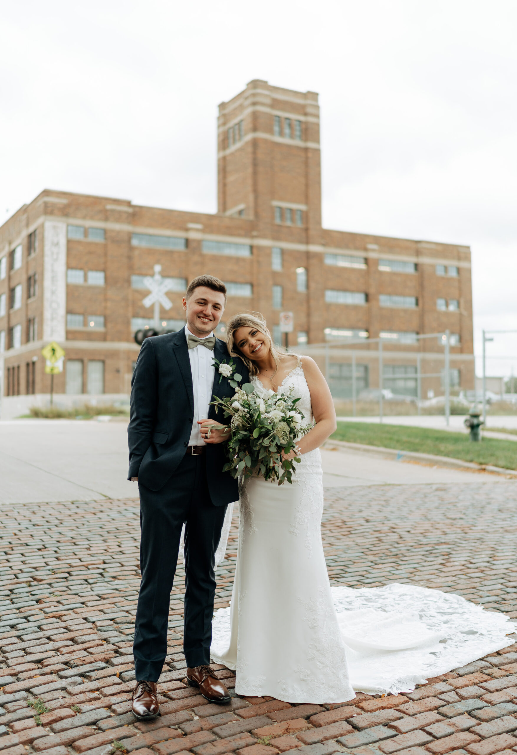 This is a picture of the bride and groom on their wedding day outside of the Harmac in Cedar Rapids, IA
