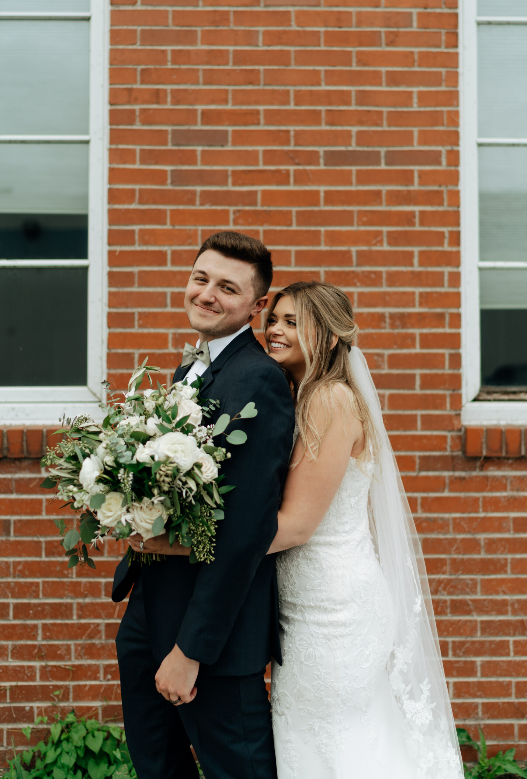 This is a picture of the bride and groom on their wedding day outside of the Harmac in Cedar Rapids, IA