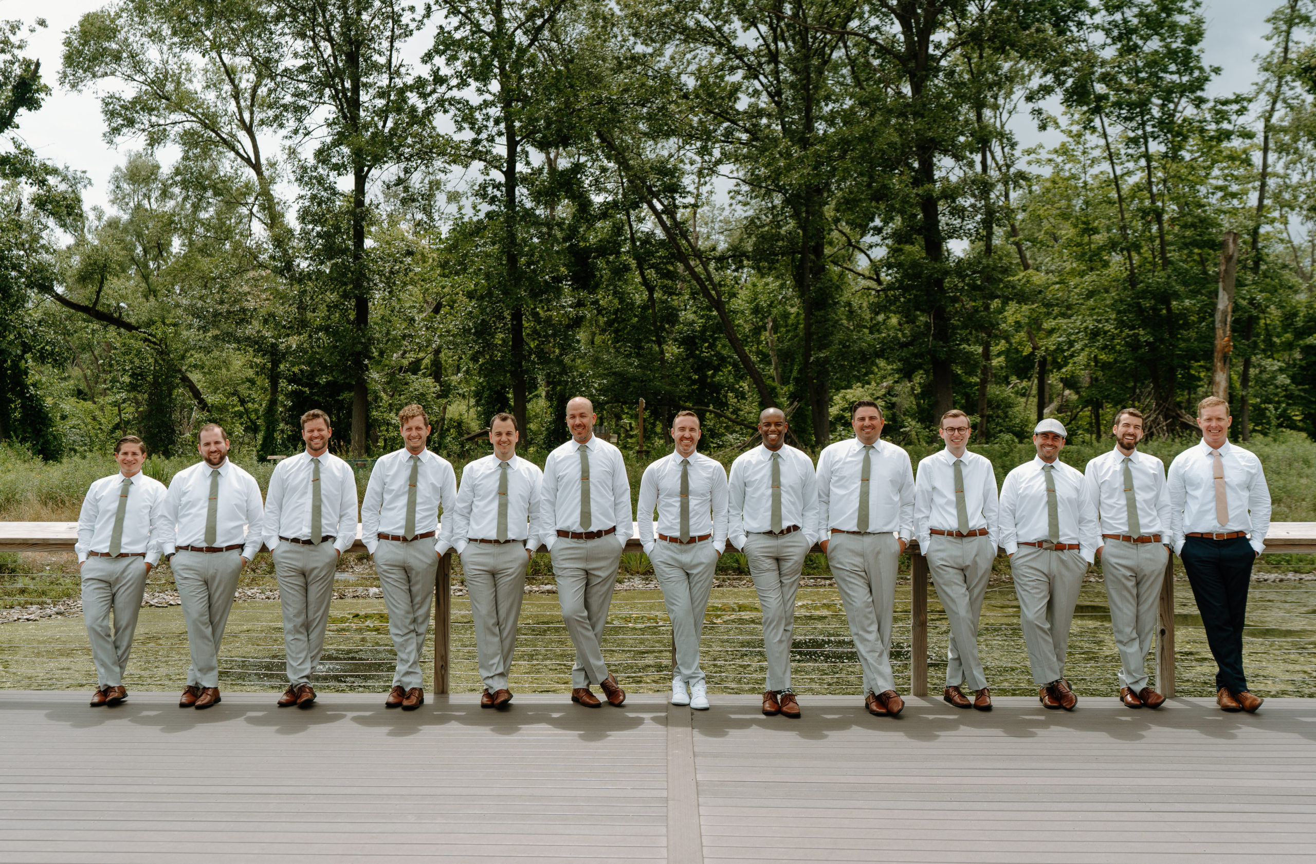 This is a groom with his groomsmen taking a picture on his wedding day