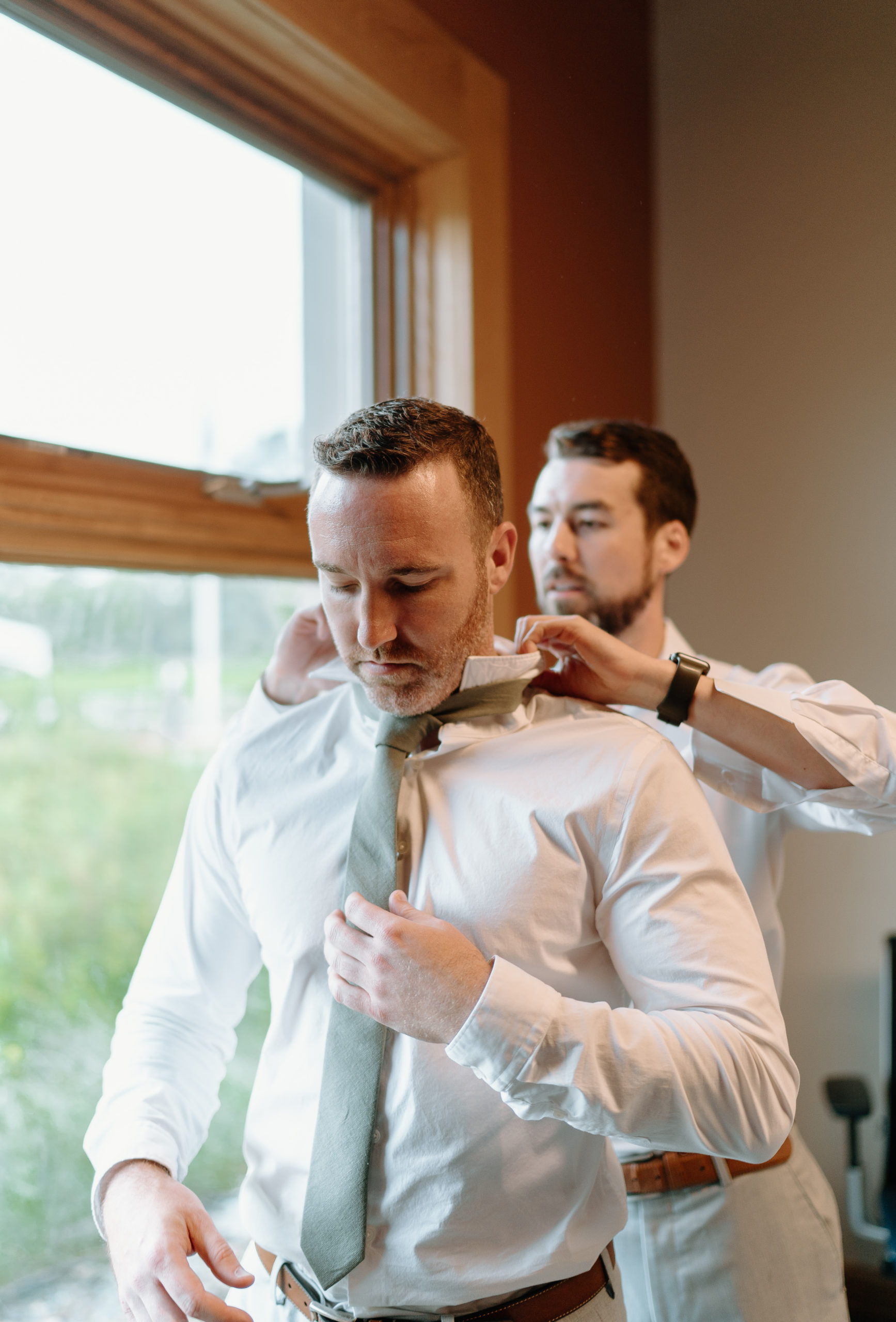 This is a groom getting dressed on his wedding day