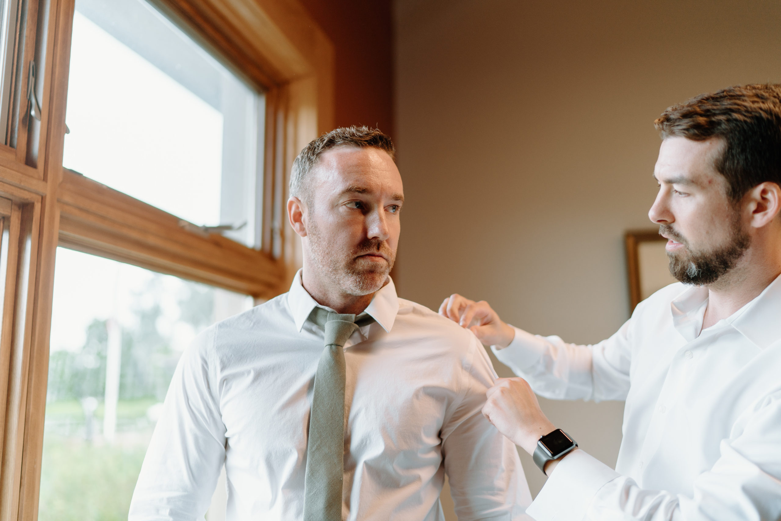 This is a groom getting dressed on his wedding day