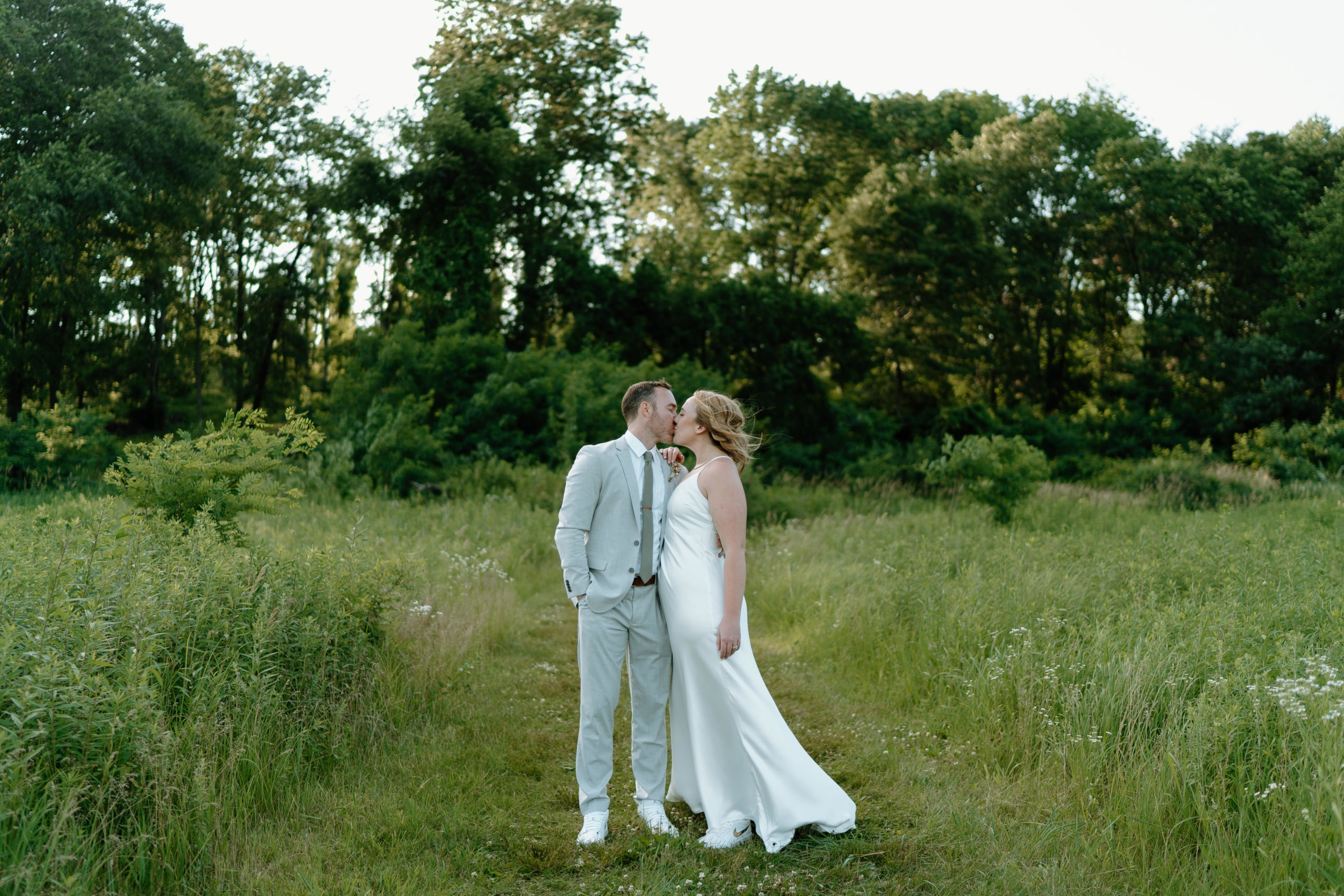 This is a bride and groom taking portraits on their wedding day at Indian Creek Nature Center in Cedar Rapids, IA