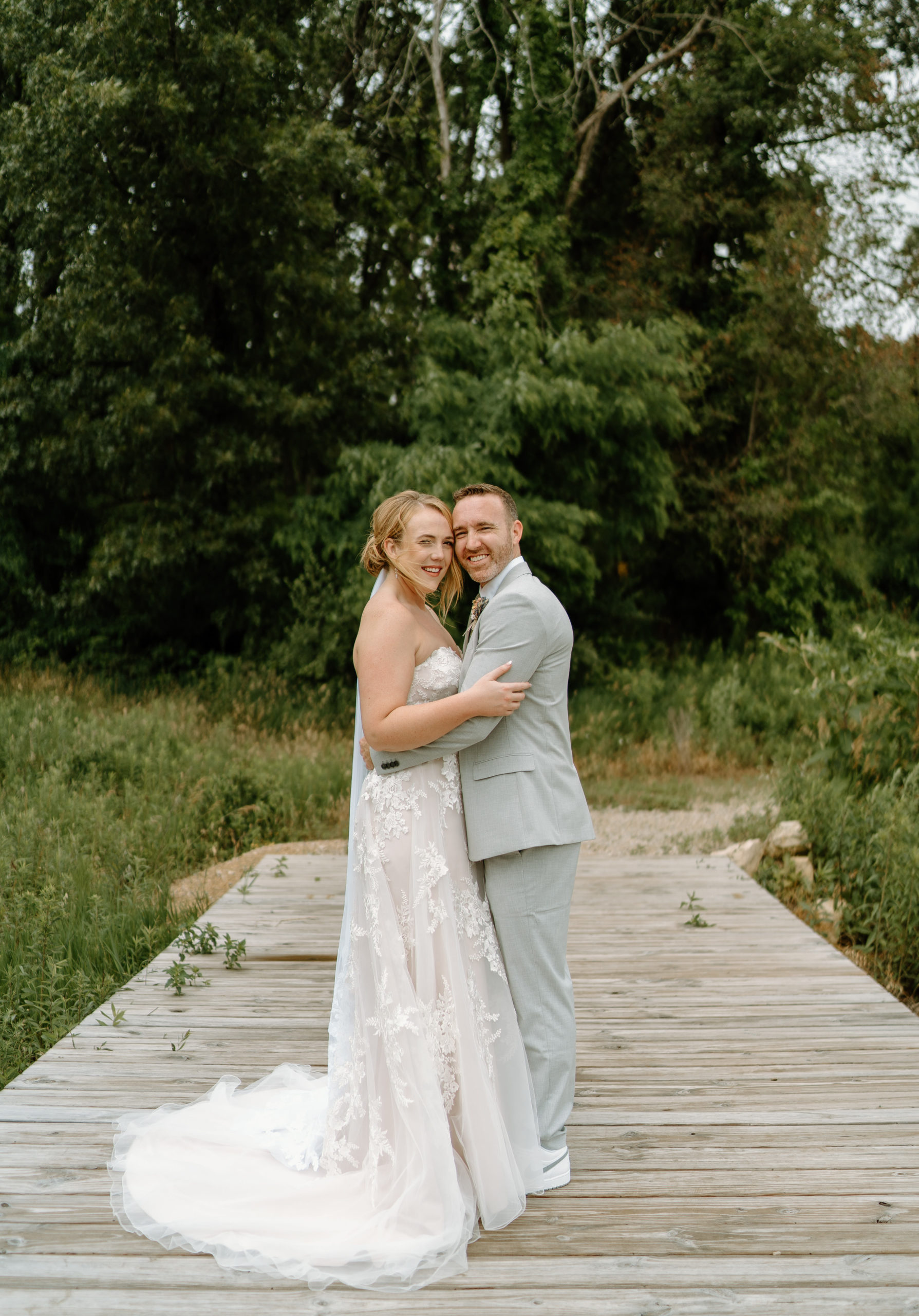This is a bride and groom doing their first look on their wedding day at Indian Creek Nature Center in Cedar Rapids, IA