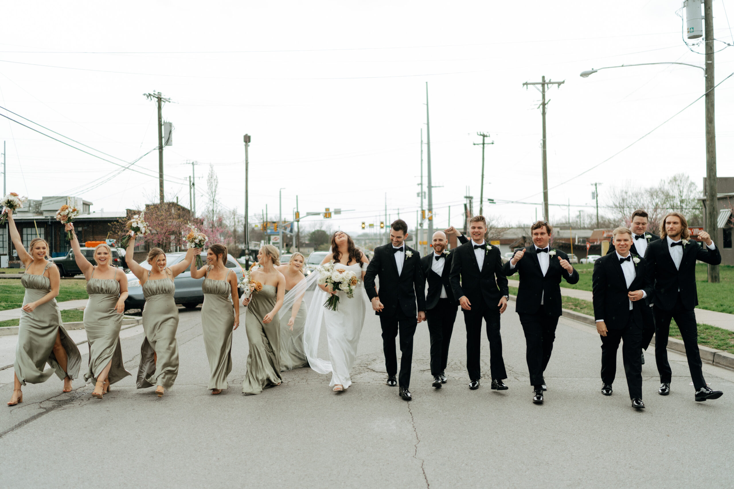 bride and groom celebrating with their bridal party at 14tenn in nashville, tennessee