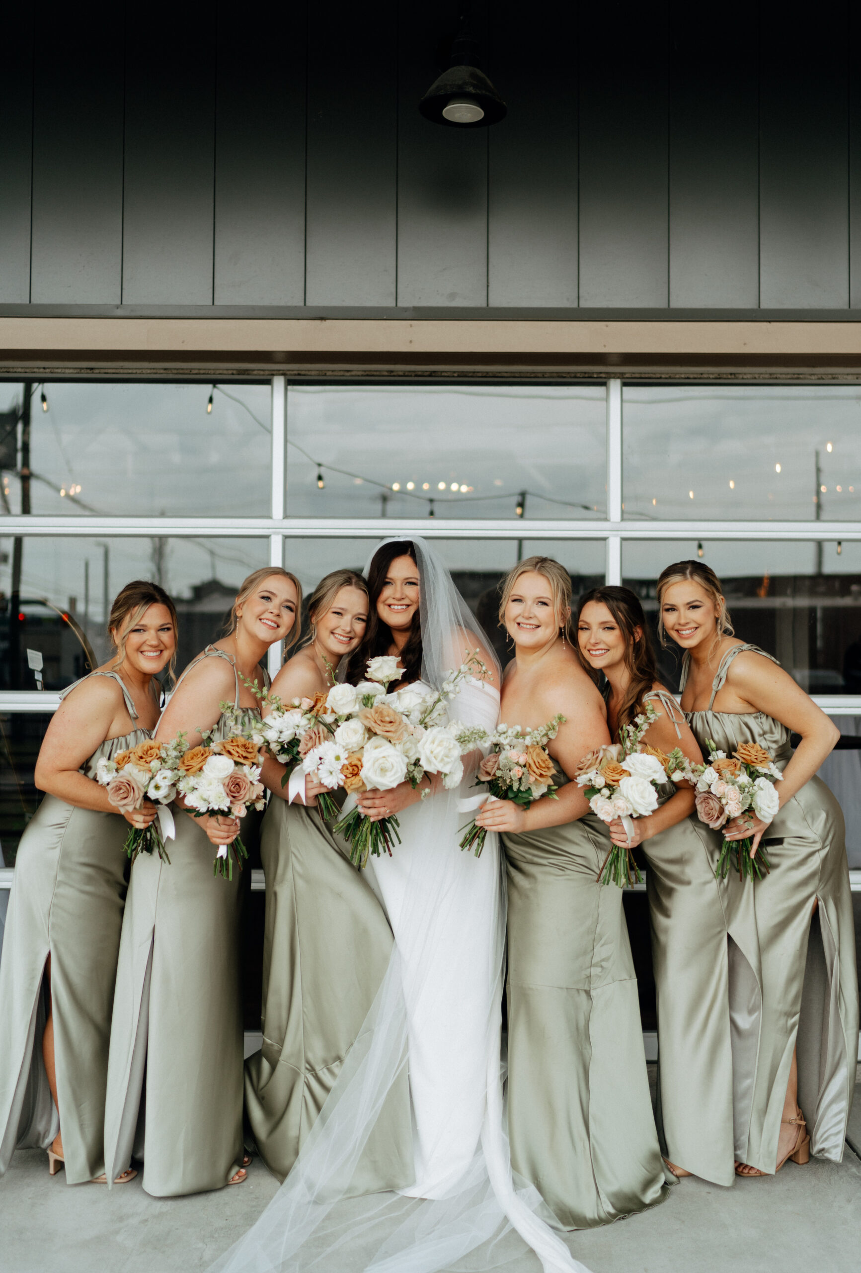 Bride with her bridesmaids taking pictures on her wedding day at 14TENN in Nashville, TN