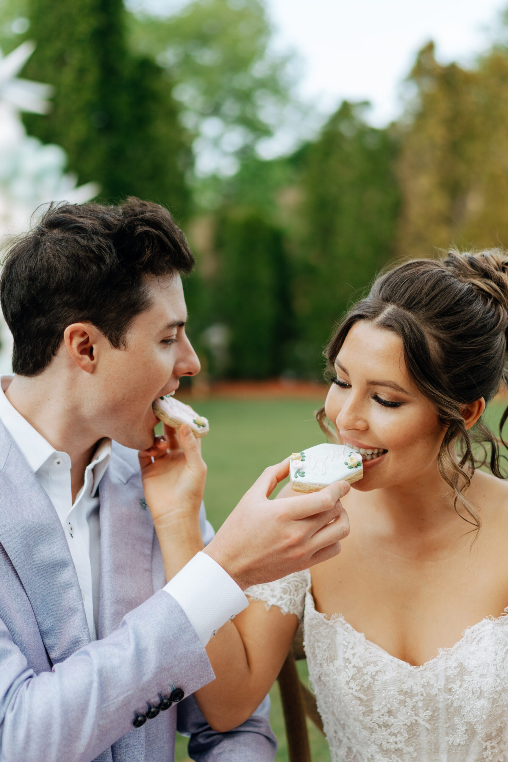 couple feeding eachother cake on their wedding day