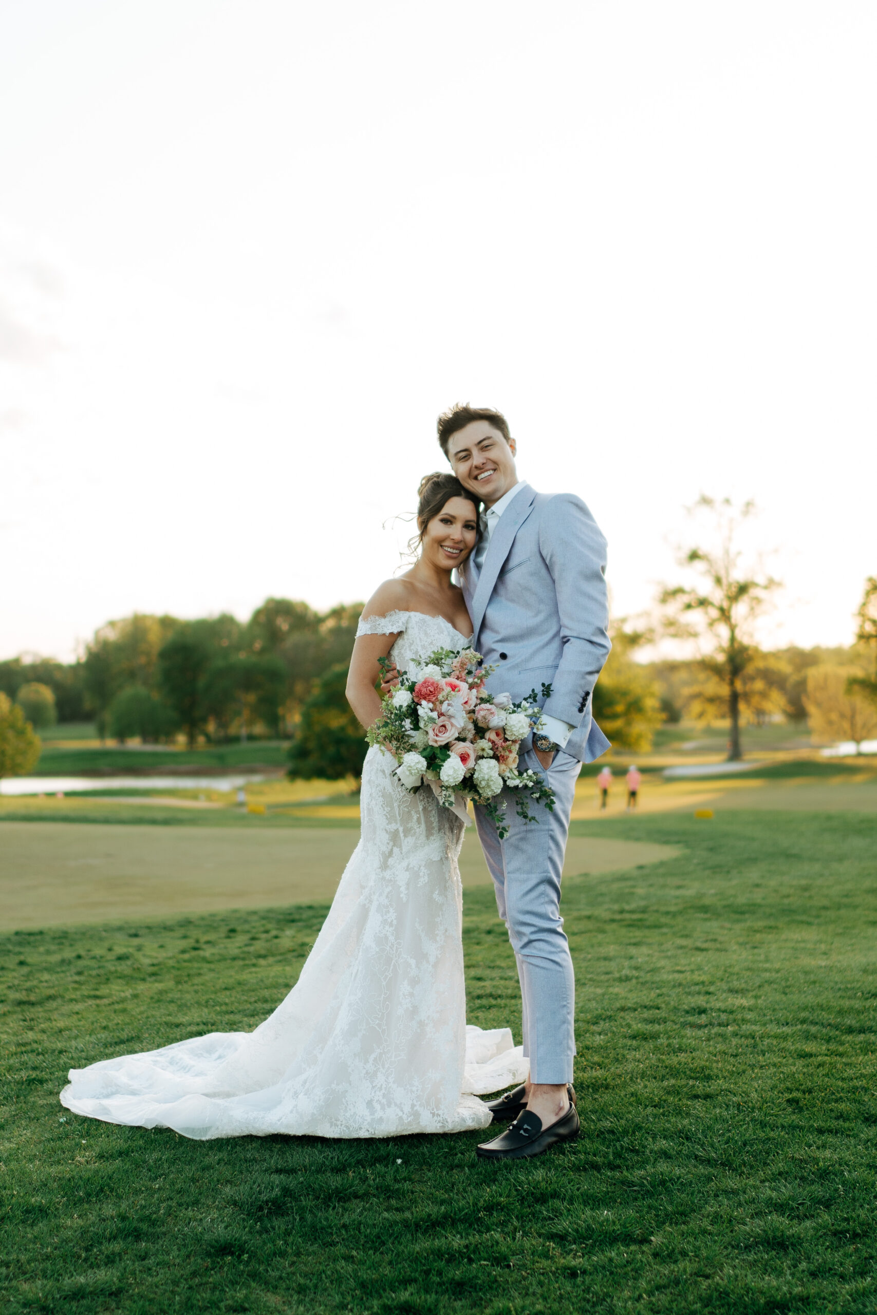 couple taking pictures on their wedding day at Hermitage Golf