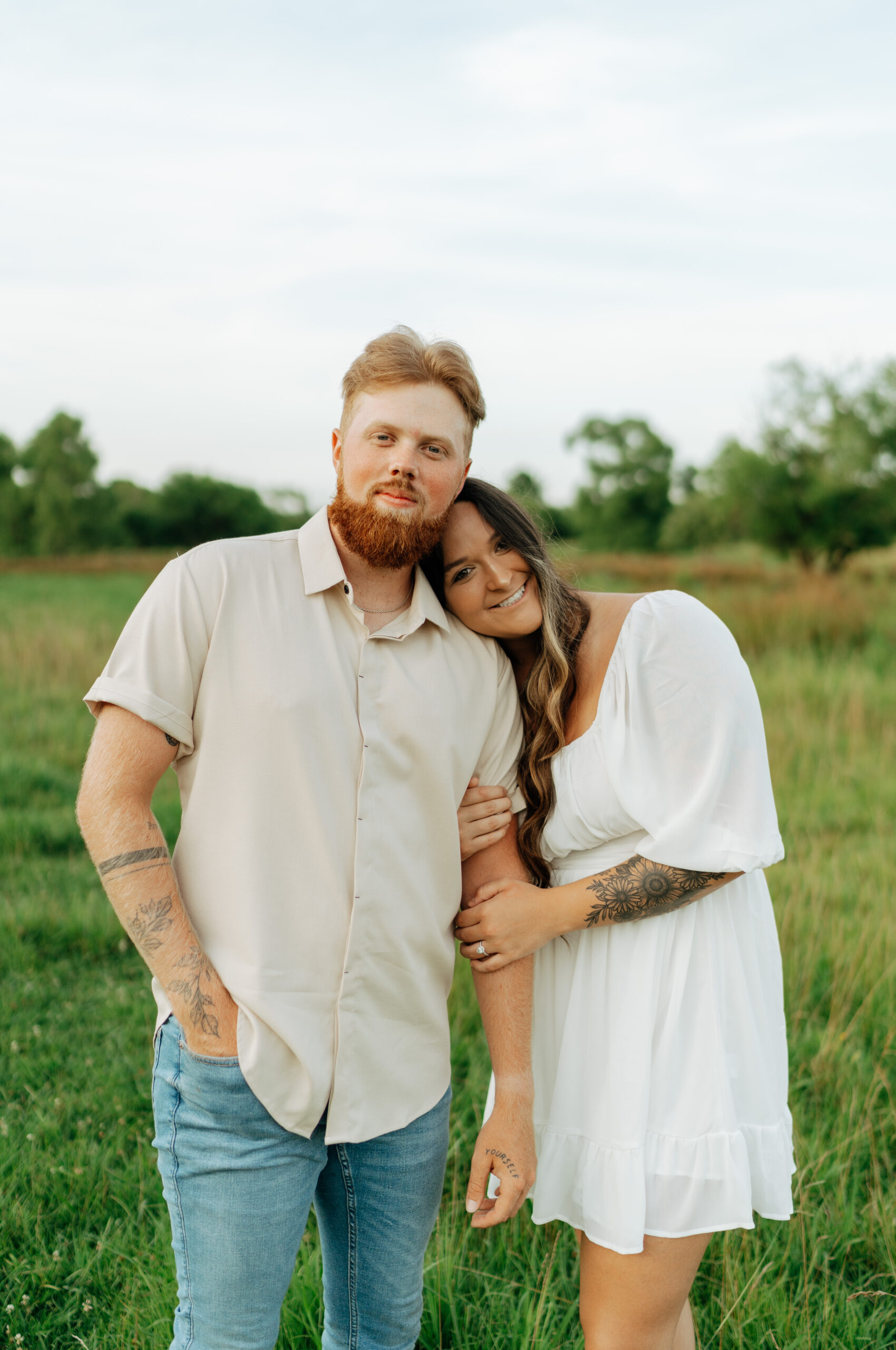 couple taking engagement pictures at cornelia fort airpark in nashville, tennessee