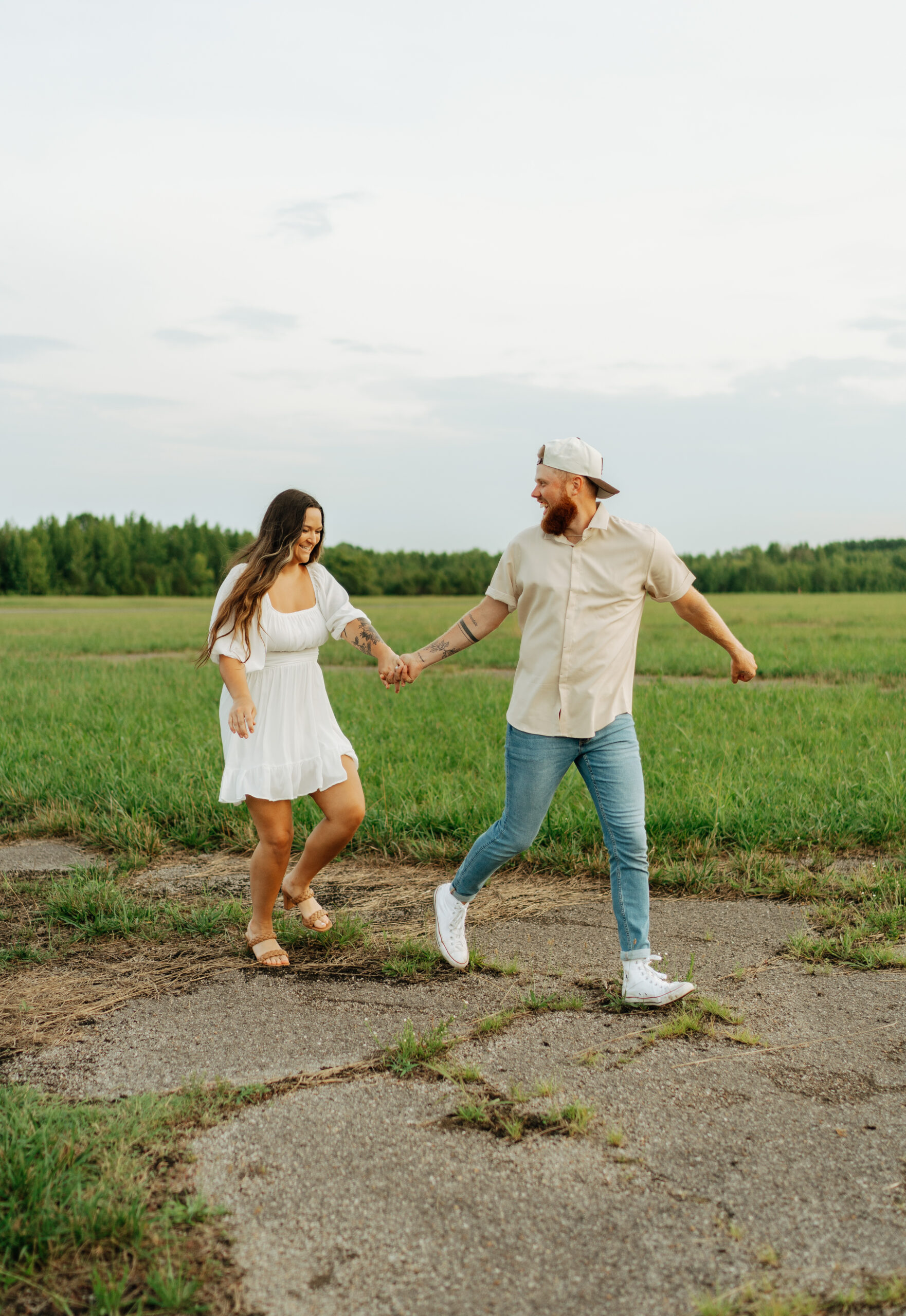 couple taking engagement pictures at cornelia fort airpark in nashville, tennessee