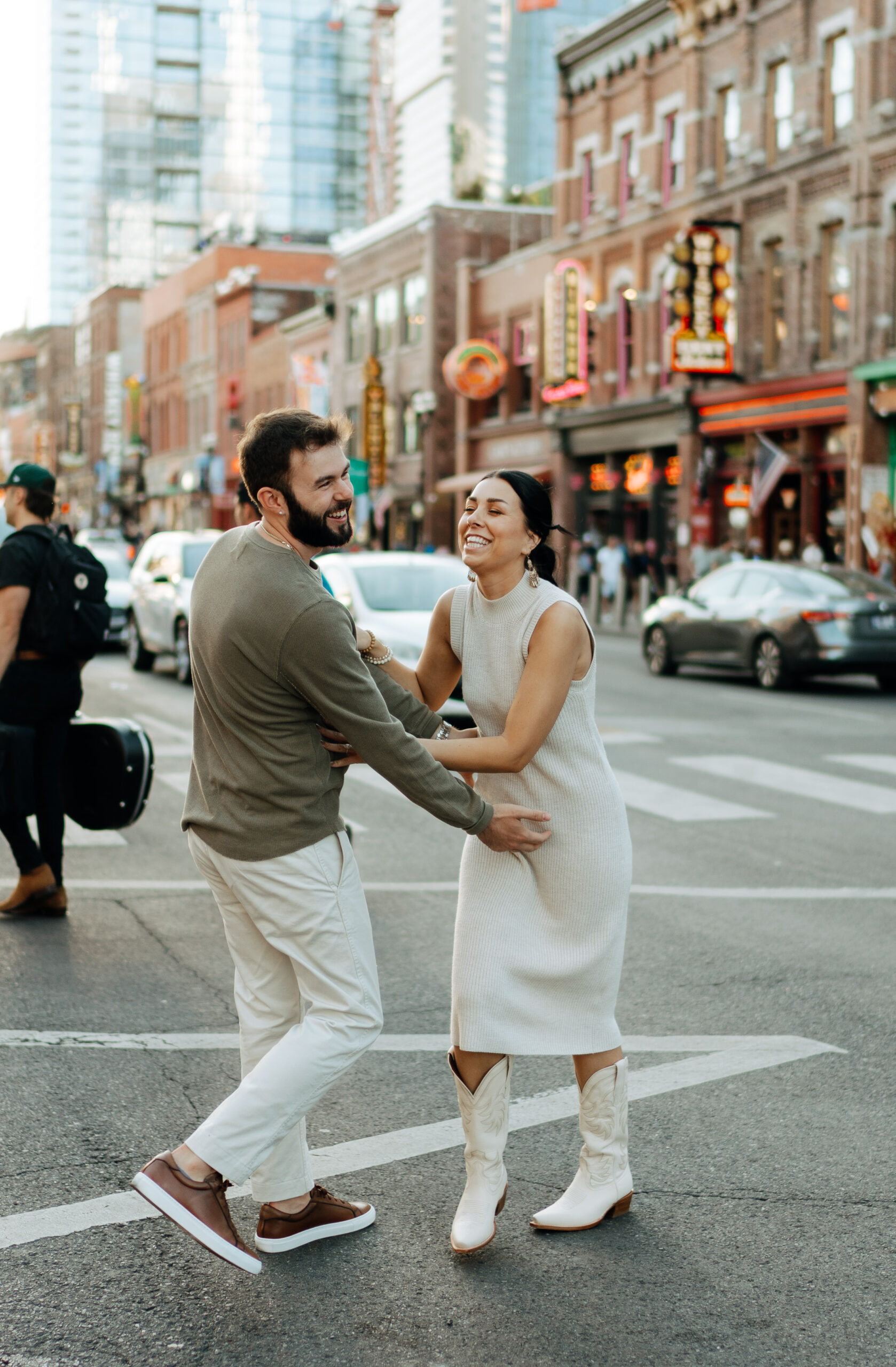 couple taking pictures for their downtown nashville engagement session