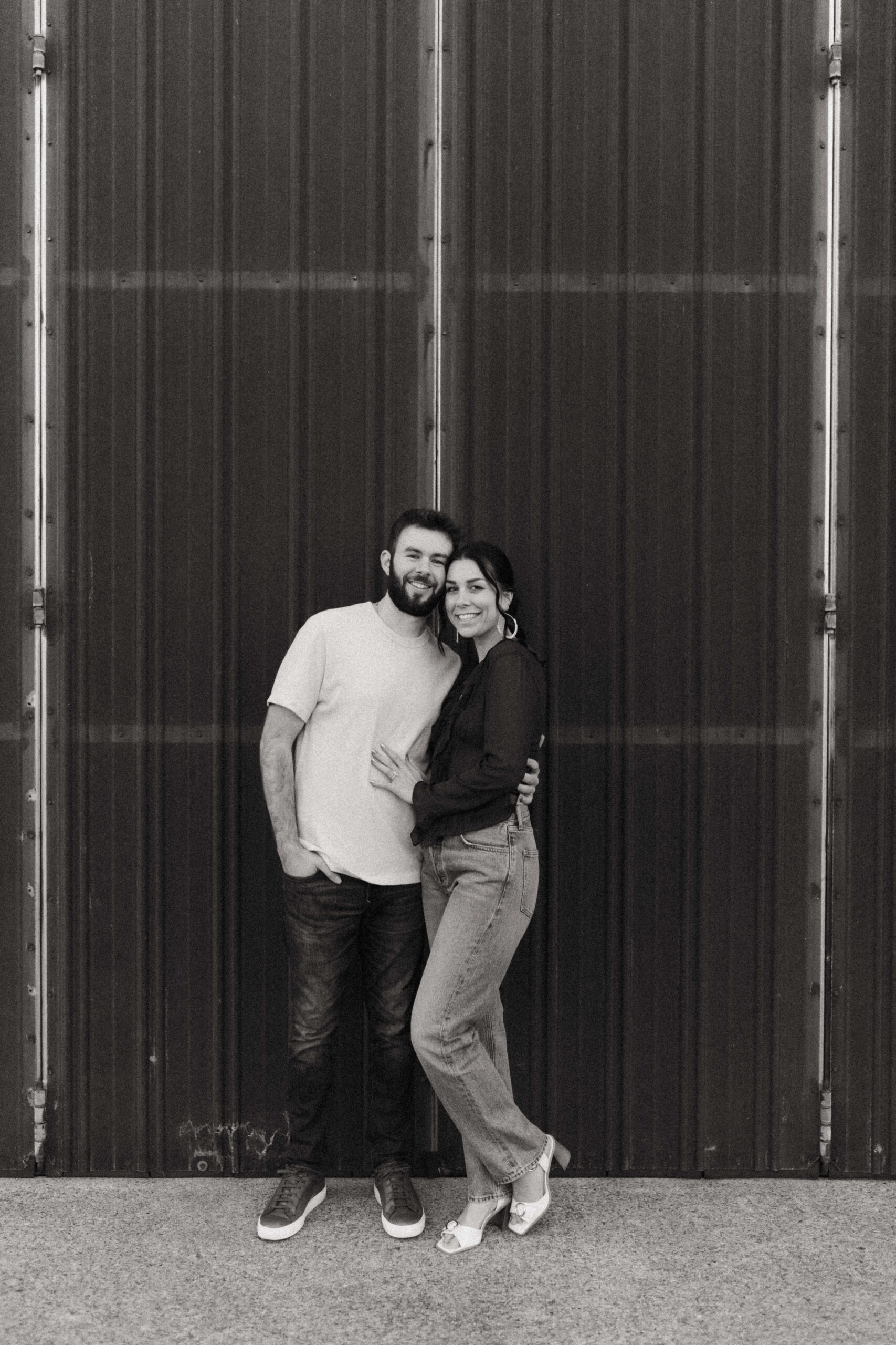 couple taking pictures for their downtown nashville engagement session